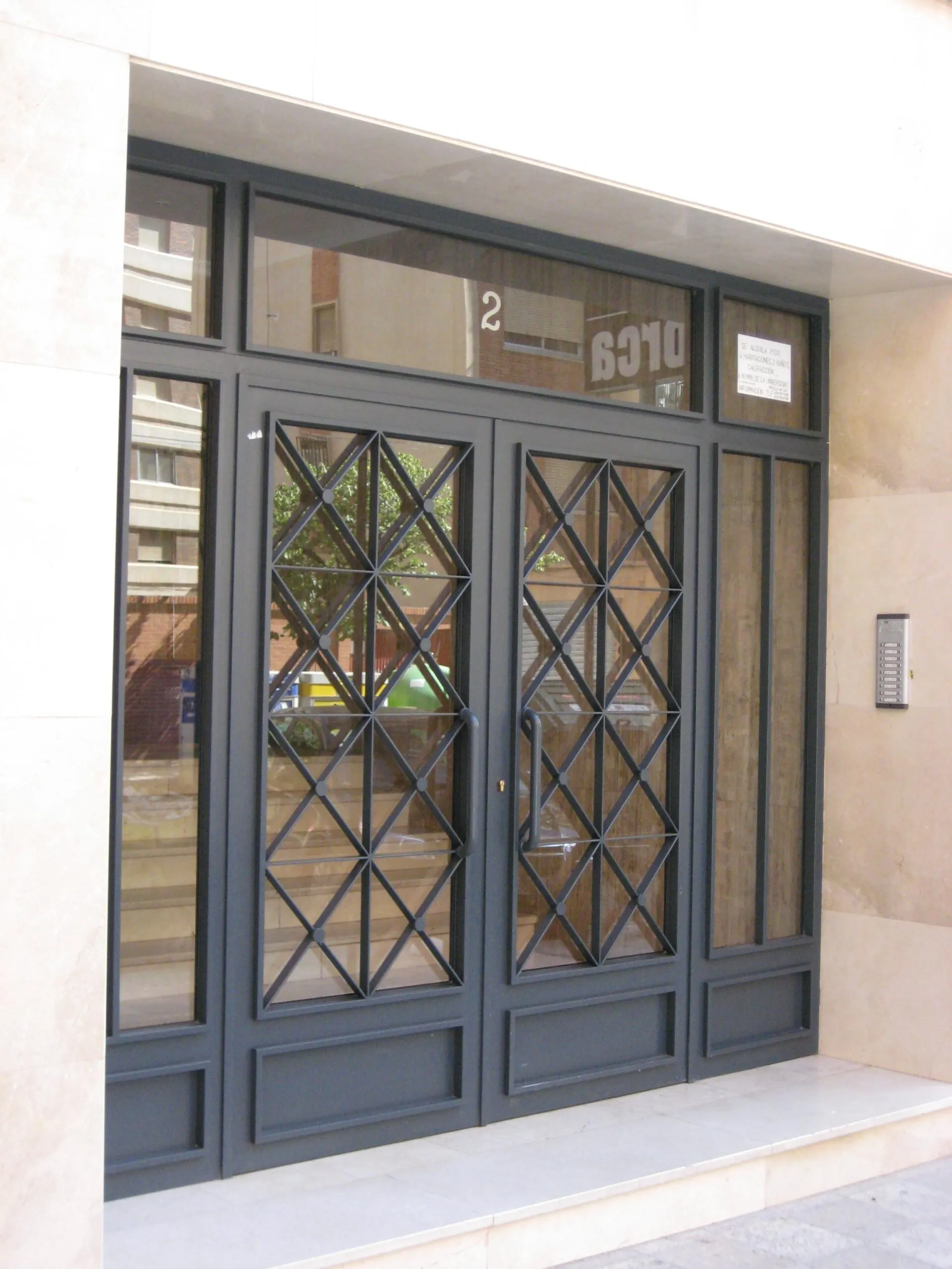 puertas de comunidades scaled - Venta e Instalaci&oacute;n Rejas para Ventanas Barcelona